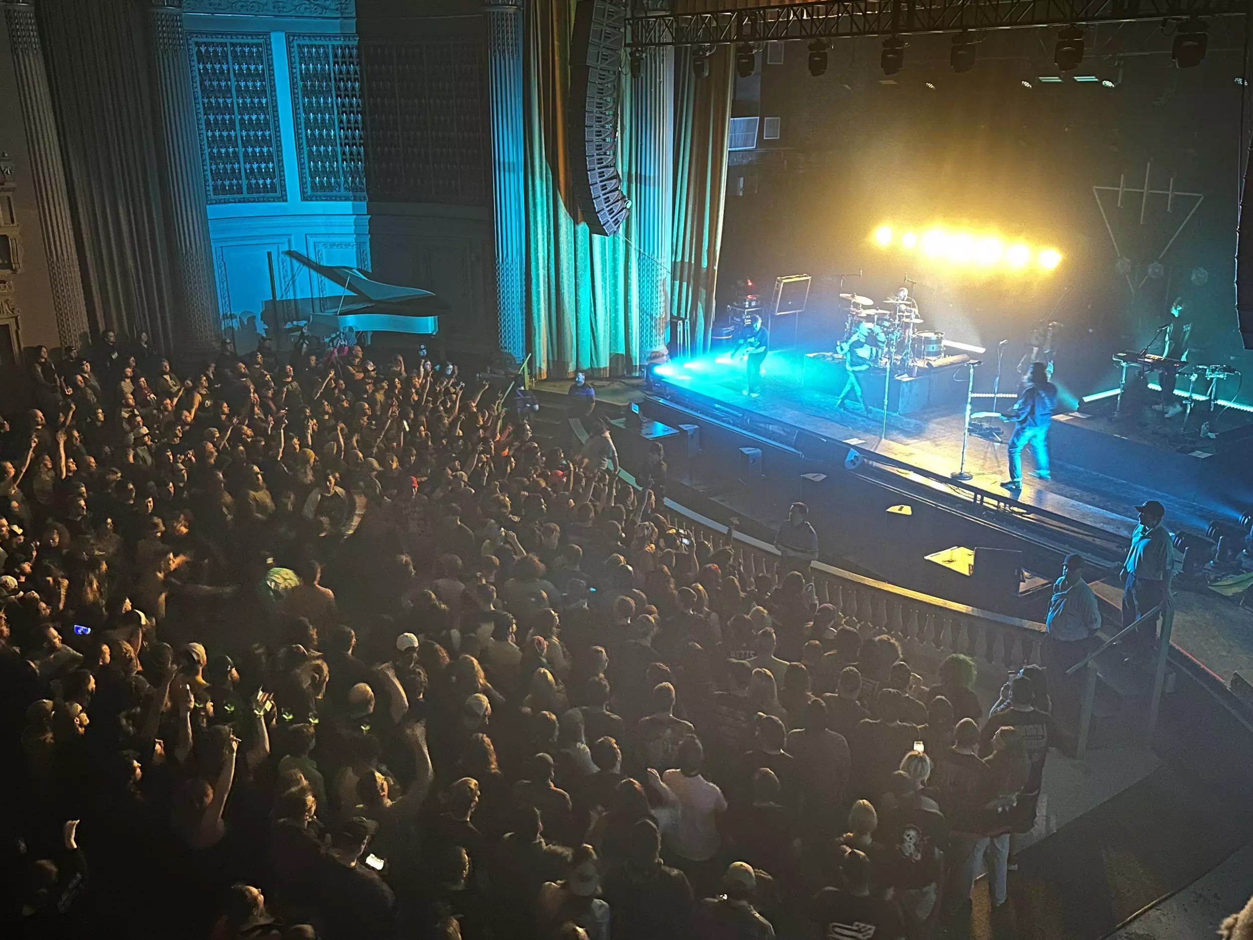 Live music concert venue with energetic crowd and dramatic stage lighting